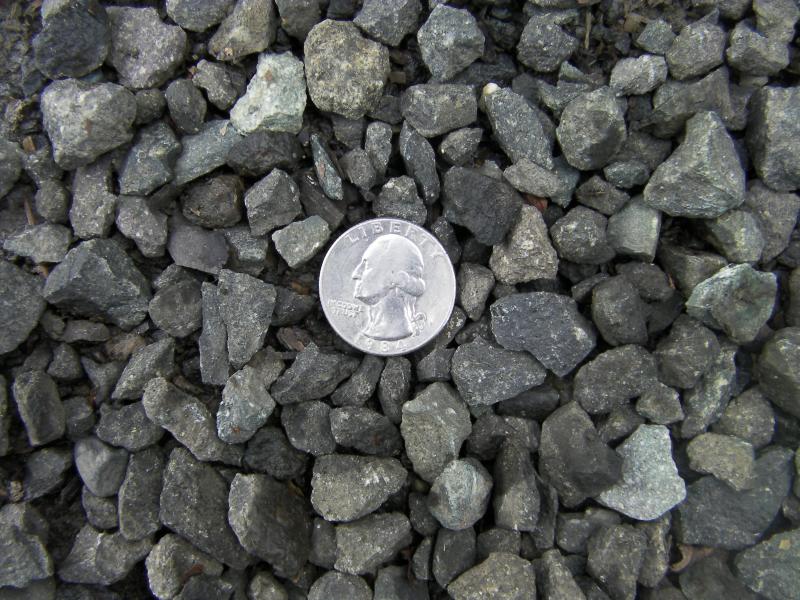 5/8th minus dark gray basalt with quarter to help show approx size.